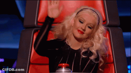 Woman Sitting In Chair With Hand Up GIF