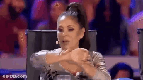 Woman Sitting In Chair With Hands Folded At Microphone GIF
