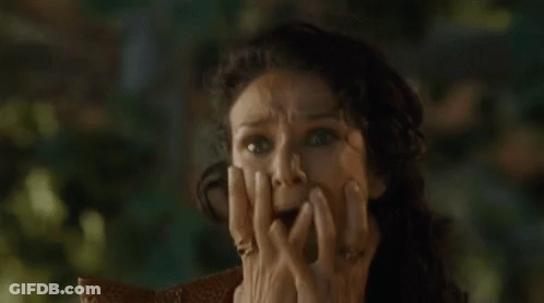 Woman Sitting In Chair With Hands On Face GIF