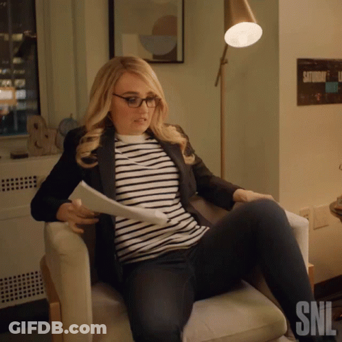 Woman Sitting In Chair With SNL Logo GIF