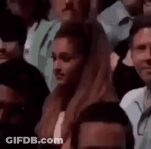 Woman Sitting In Crowd Looking GIF