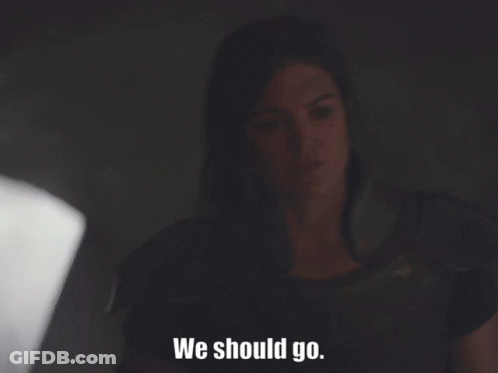 Woman Sitting In Dark Room Saying We Should Go GIF