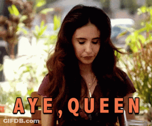 Woman Sitting In Front Of Aye Queen Sign GIF