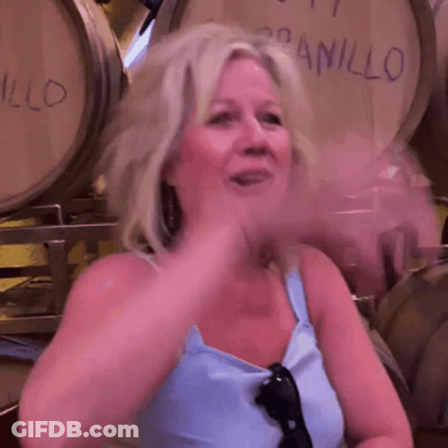 Woman Sitting In Front Of Barrels Saying Anillo GIF