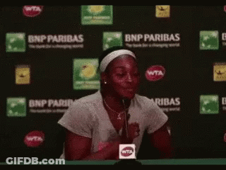 Woman Sitting In Front Of BNP Paribas Sign GIF