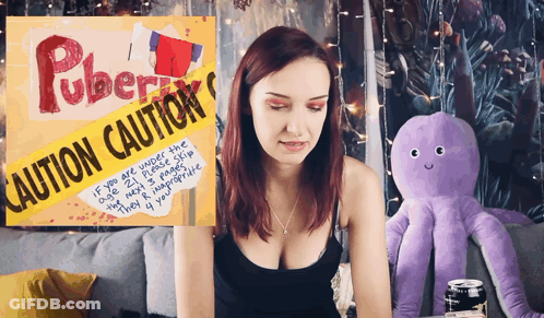 Woman Sitting In Front Of Caution Sign GIF