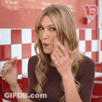 Woman Sitting In Front Of Checkered Wall GIF
