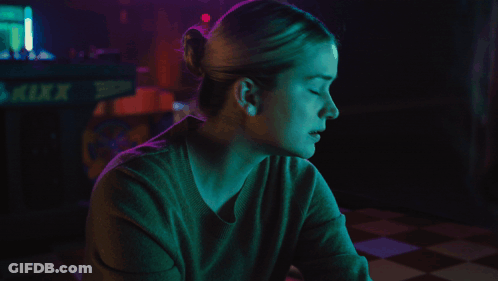 Woman Sitting In Front Of Kixx Sign GIF