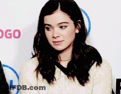 Woman Sitting In Front Of Logo Wall GIF