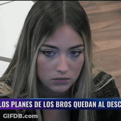 Woman Sitting In Front Of Los Planes De Los Bros Quedan Al Desc Sign GIF