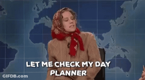 Woman Sitting In Front Of Map Holding Notebook Saying Let Me Check My Day Planner GIF