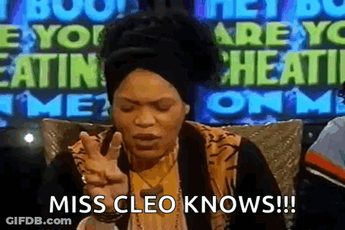 Woman Sitting In Front Of Miss Cleo Knows Sign GIF