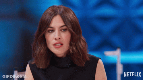 Woman Sitting In Front Of Netflix Sign GIF