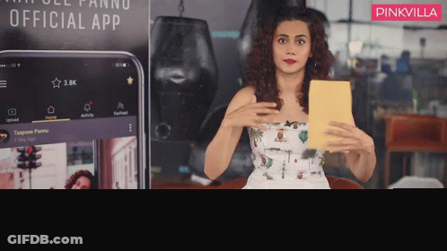 Woman Sitting In Front Of Pinkvilla Sign GIF