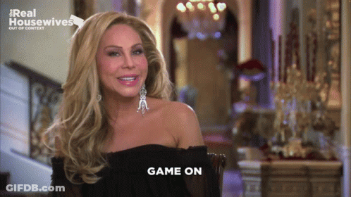 Woman Sitting In Front Of Real Housewives Logo GIF