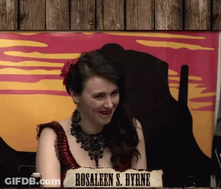 Woman Sitting In Front Of Rosaleen S. Byrne Sign GIF
