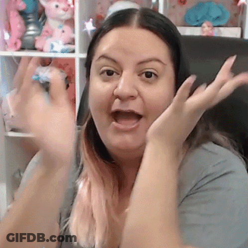Woman Sitting In Front Of Shelf With Stuffed Animals GIF