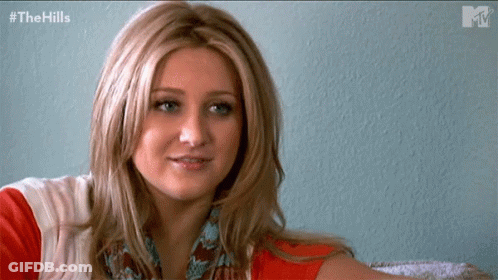 Woman Sitting In Front Of The Hills Wall GIF