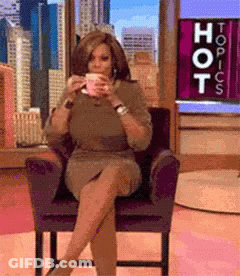 Woman Sitting In Front Of Topics Sign GIF