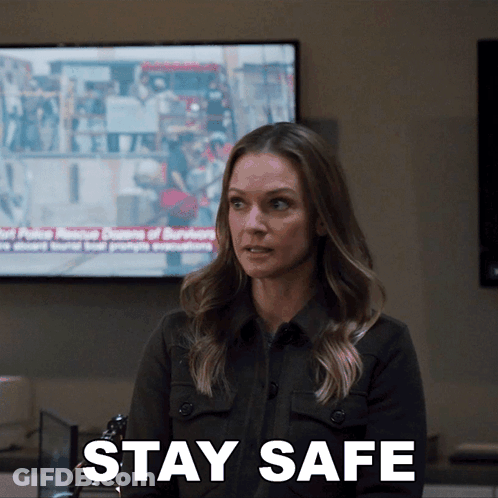 Woman Sitting In Front Of TV Saying Stay Safe GIF