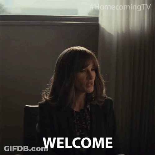 Woman Sitting In Front Of Welcome Sign GIF