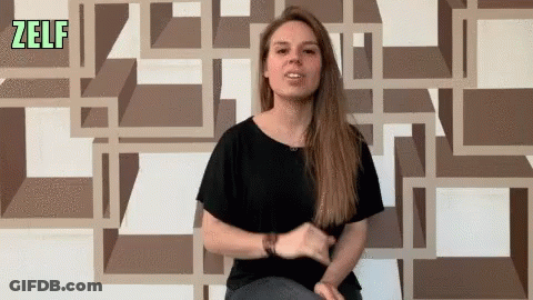 Woman Sitting In Front Of Zelf Wall GIF