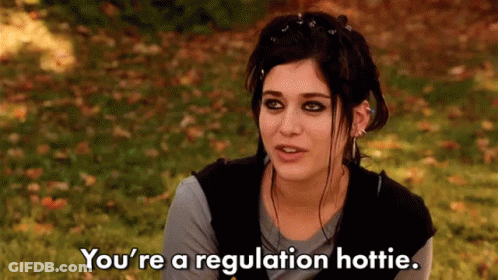 Woman Sitting In Grass Saying You're A Regulation Hottie GIF