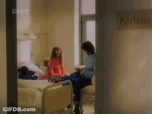 Woman Sitting In Hospital Chair Next To Kortek Sign GIF