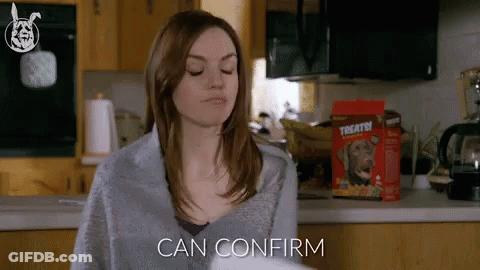 Woman Sitting In Kitchen With Box Of Treats GIF