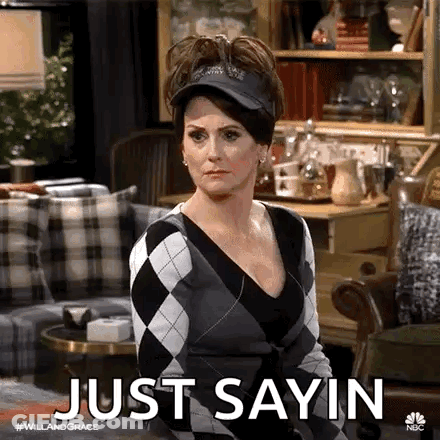 Woman Sitting In Living Room Wearing Hat And Sweater GIF