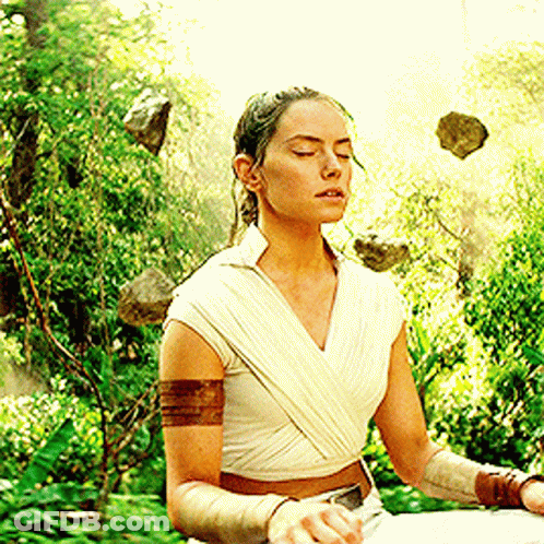 Woman Sitting In Lotus Position With Rocks Flying GIF