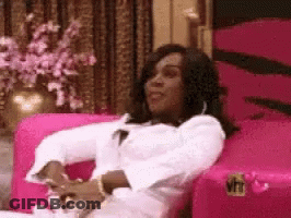 Woman Sitting In Pink Chair With VH1 Logo GIF