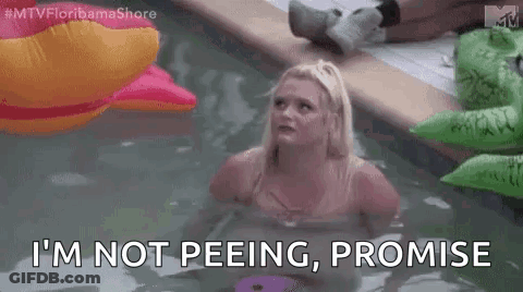 Woman Sitting In Pool With Inflatable Crocodile And Pink Duck GIF