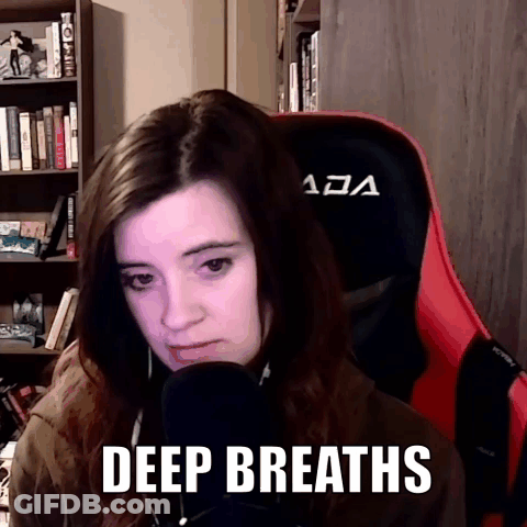 Woman Sitting In Red Chair Deep Breaths GIF