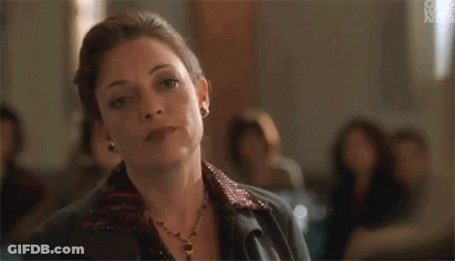 Woman Sitting In Room With Group GIF
