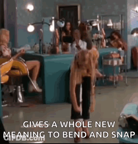 Woman Sitting In Salon With Standing Woman GIF