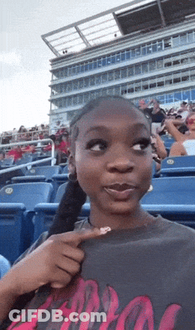 Woman Sitting In Stadium Wearing Apollo Shirt GIF