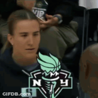 Woman Sitting In Stadium With NY Logo Sweatshirt GIF