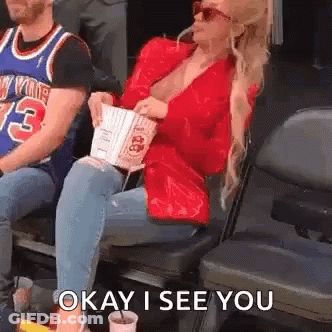 Woman Sitting In Stadium With Popcorn And Soda GIF