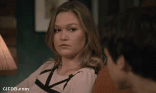 Woman Sitting Next To Man On Couch Looking At Camera GIF