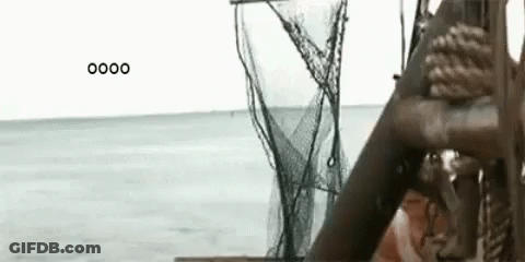 Woman Sitting On A Boat With Fishing Net In Ocean GIF