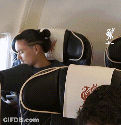 Woman Sitting On Airplane With LFC Logo GIF