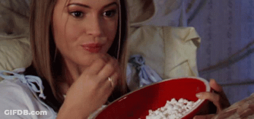 Woman Sitting On Bed Eating Popcorn GIF