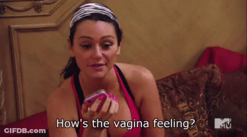 Woman Sitting On Bed Holding Cell Phone Saying How's The Vagina Feeling GIF