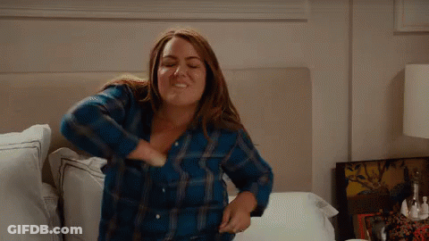 Woman Sitting On Bed In Blue Plaid Shirt GIF