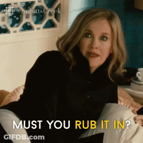 Woman Sitting On Bed With Pillow Must You Rub It In GIF