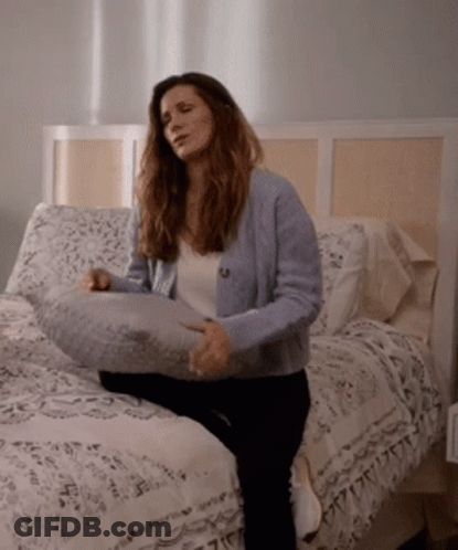 Woman Sitting On Bed With Pillow GIF