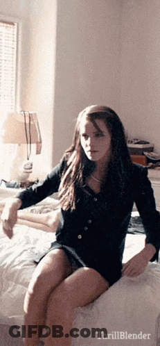 Woman Sitting On Bed With Thrillblender Text GIF