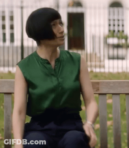 Woman Sitting On Bench Green Top Blue Pants GIF
