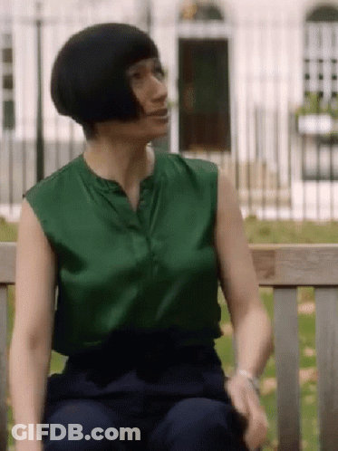 Woman Sitting On Bench Green Top Blue Pants GIF